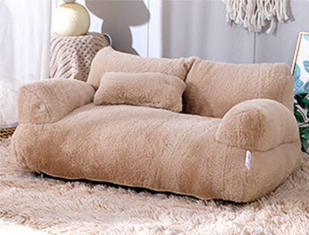 Cat lying on plush pet sofa with pillow