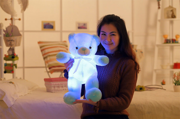 Glowing LED teddy bear in the dark