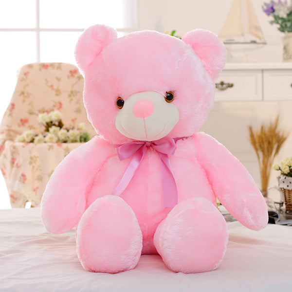 Glowing LED teddy bear in the dark
