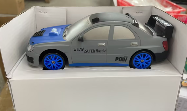 Remote control drift car sliding past cones
