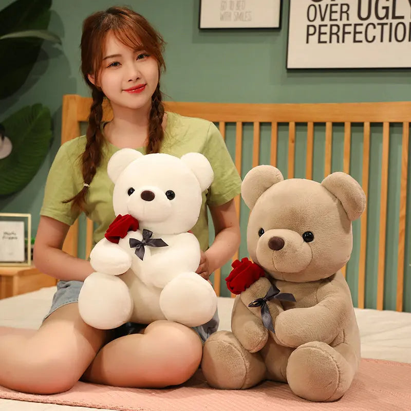 Brown teddy bear holding a red rose