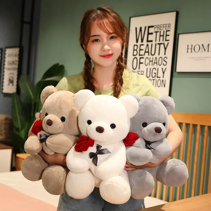 Brown teddy bear holding a red rose