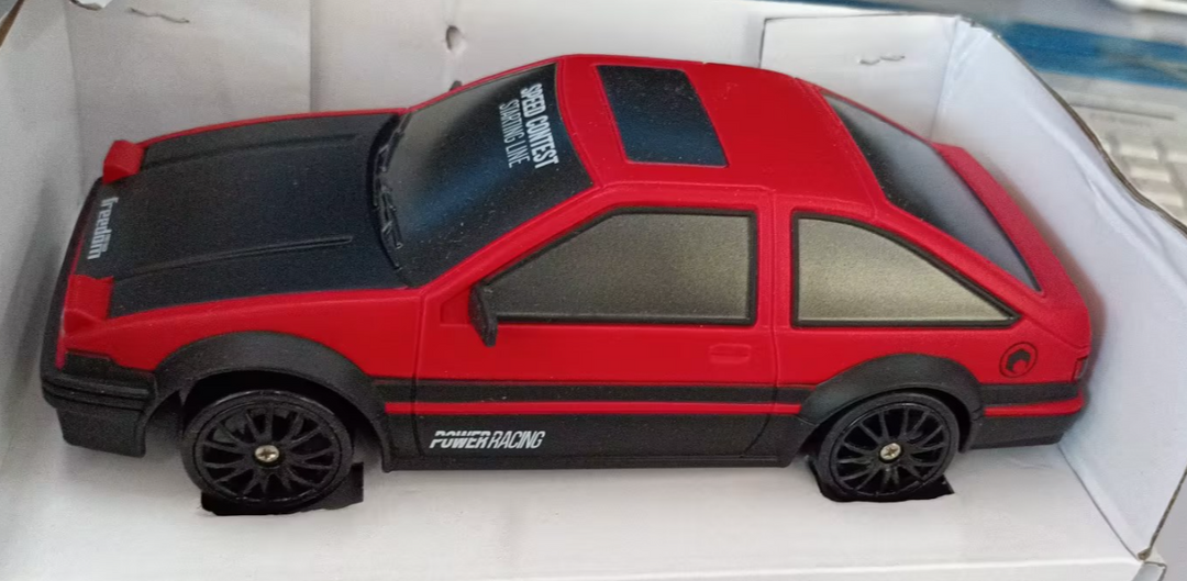 Remote control drift car sliding past cones
