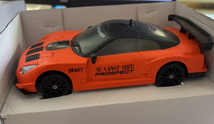 Remote control drift car sliding past cones