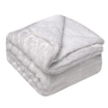 Thick sherpa blanket folded on a sofa