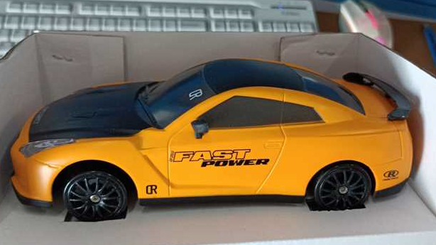 Remote control drift car sliding past cones